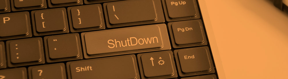 Orange-tinted close-up of a keyboard key labeled ShutDown — banner imagery from the FHG homepage What-If? carousel, 2015-2017.
